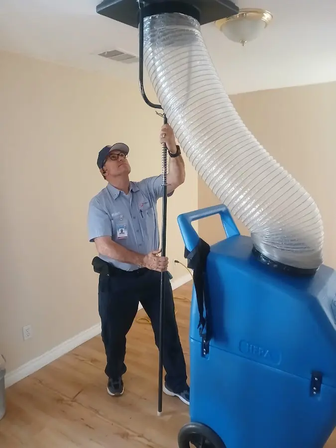 Furnace Tune-Up technician using HEPA equipment in Irvington